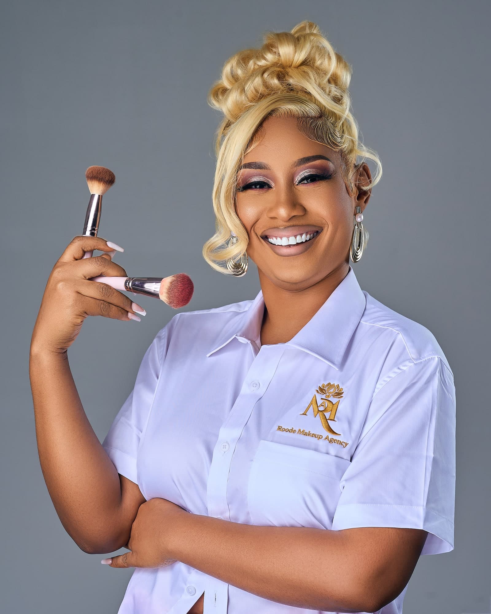ROODE Makeup Agency makeup artist holding makeup brushes
